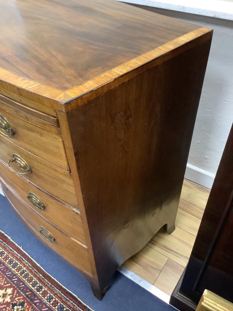A Regency mahogany satinwood banded bow-fronted chest, fitted brushing slide and four drawers on swept bracket feet, width 92cm depth 51cm height 90cm